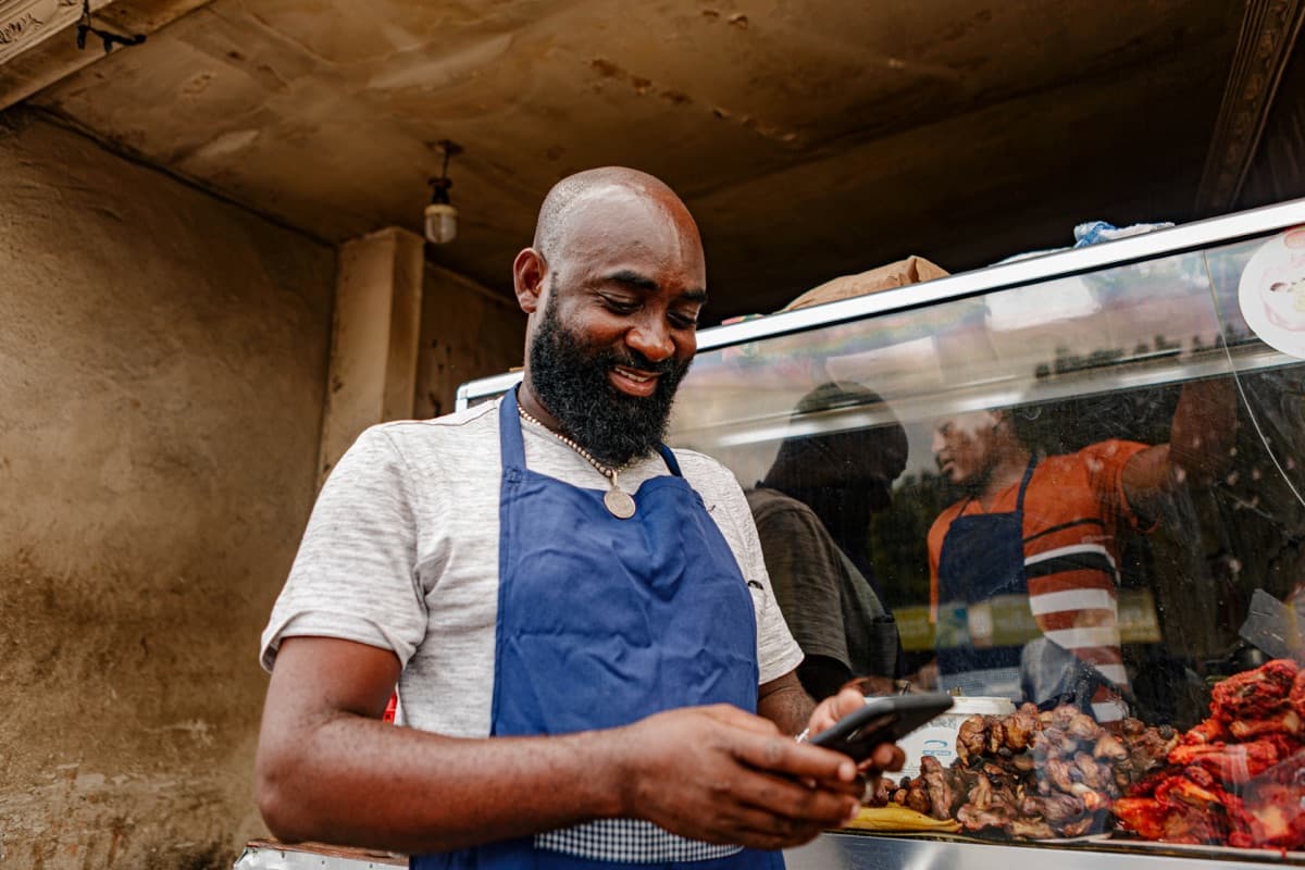 Happy South Sudan business owner growing their shop